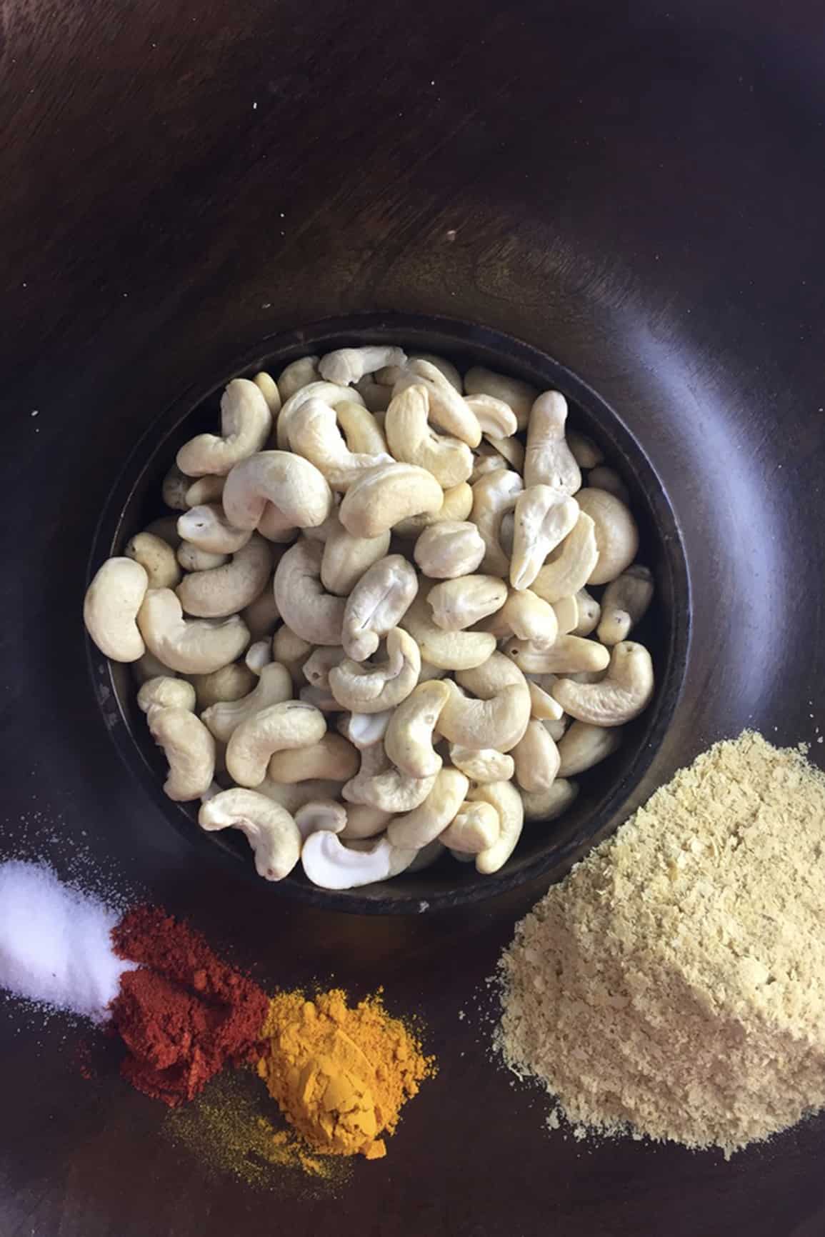 Cashews and spices on a tray.
