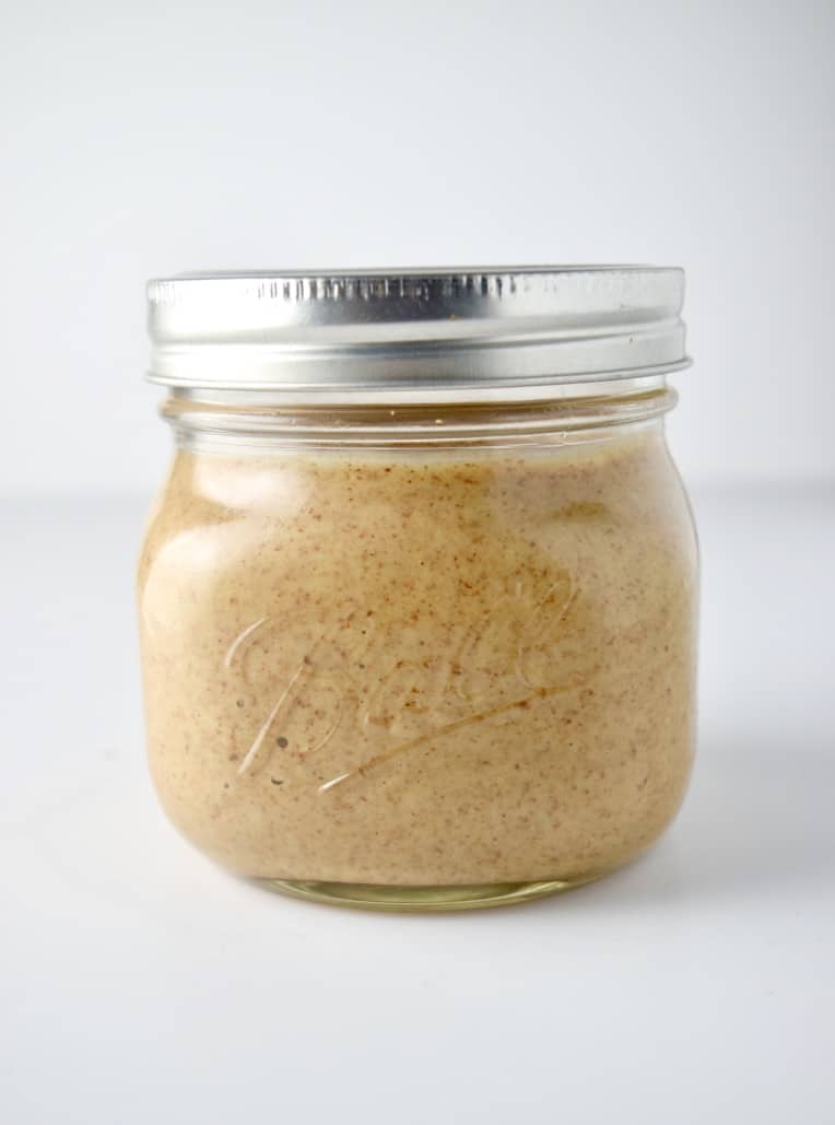Homemade almond butter in jar with lid.