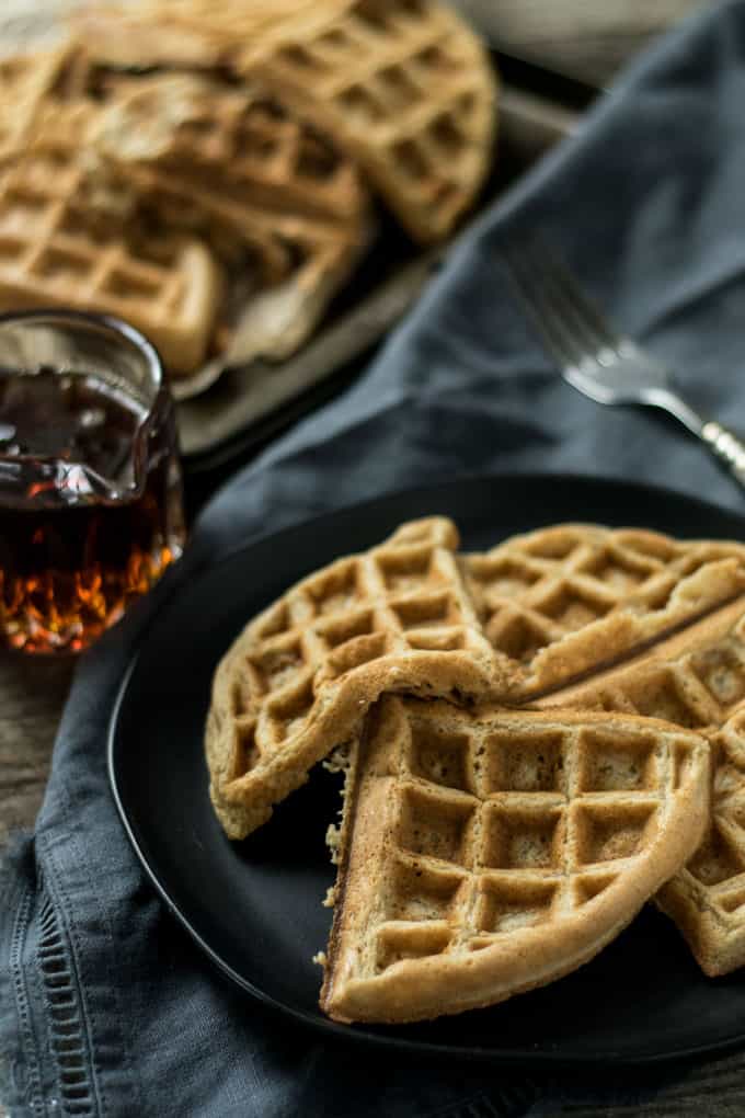 Slices of waffle on black plate.