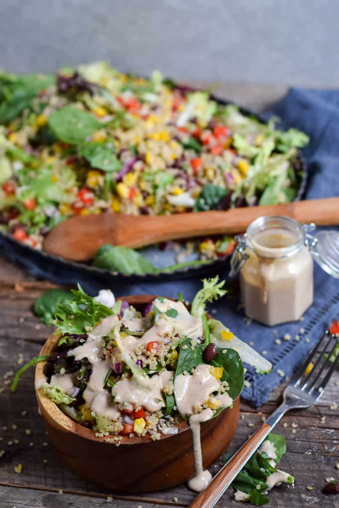 Quinoa Black Bean Summer Salad in bowl with dressing