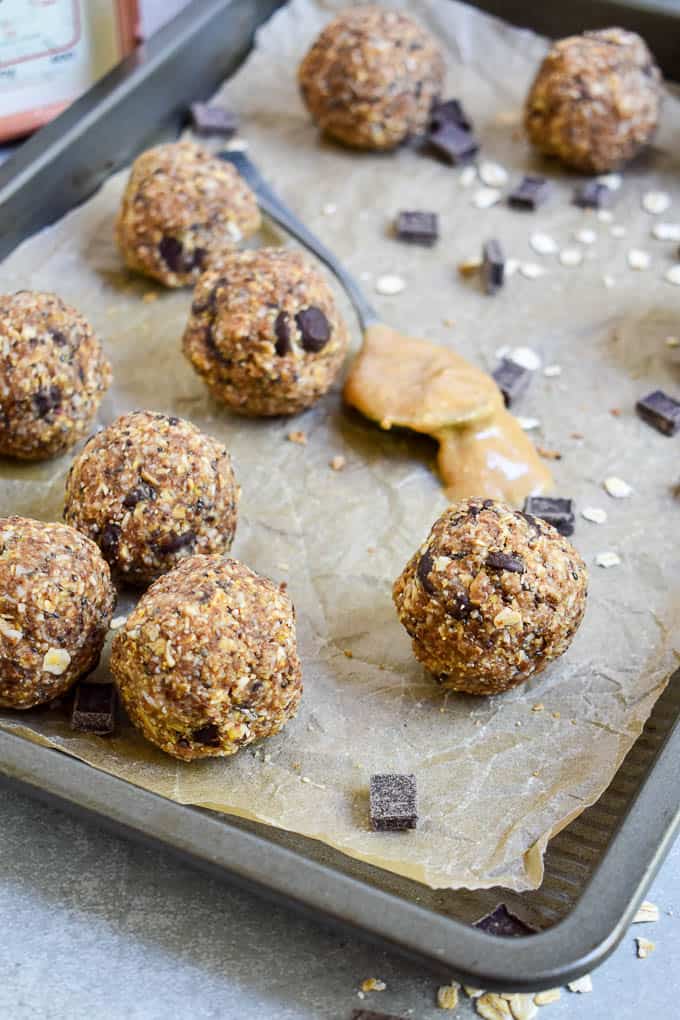 Peanut Butter Protein Energy Bites on baking sheet with oats and chocolate chips.