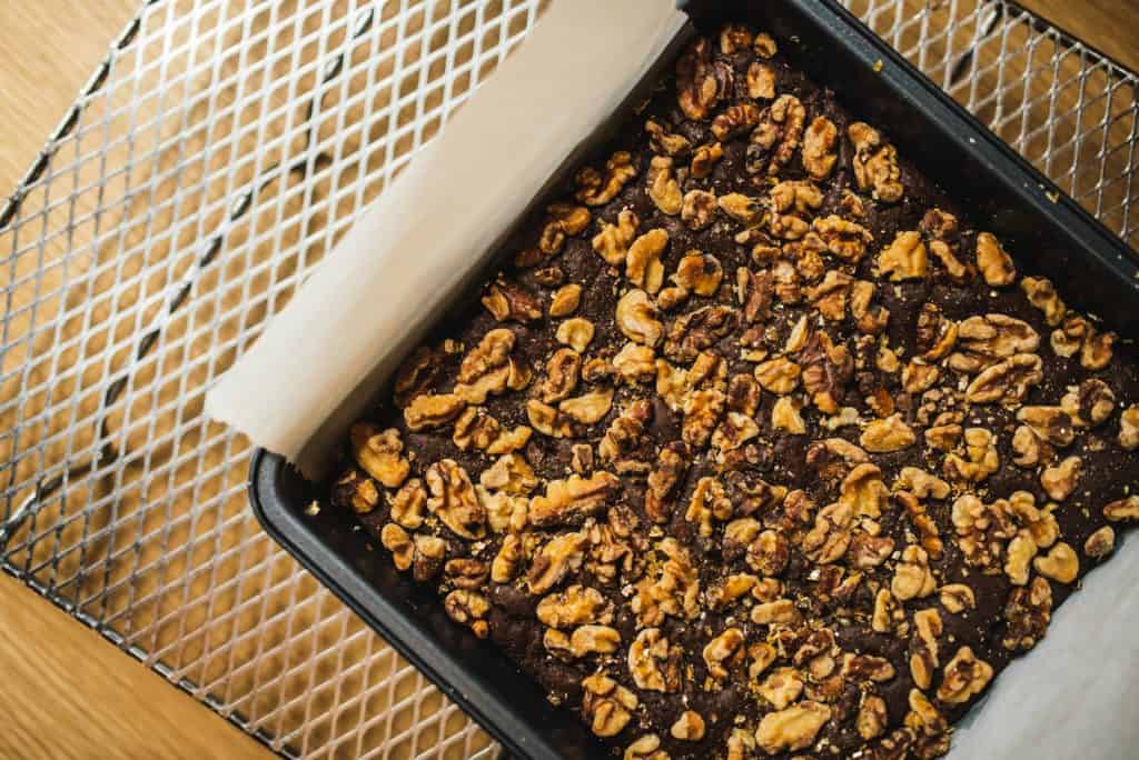 Chocolate walnut brownies on a cooling rack.