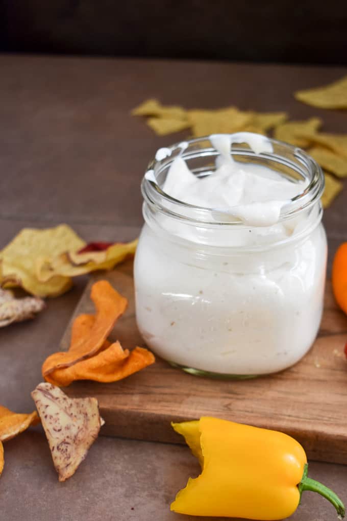 Easy vegan tofu sour cream on table with chips.