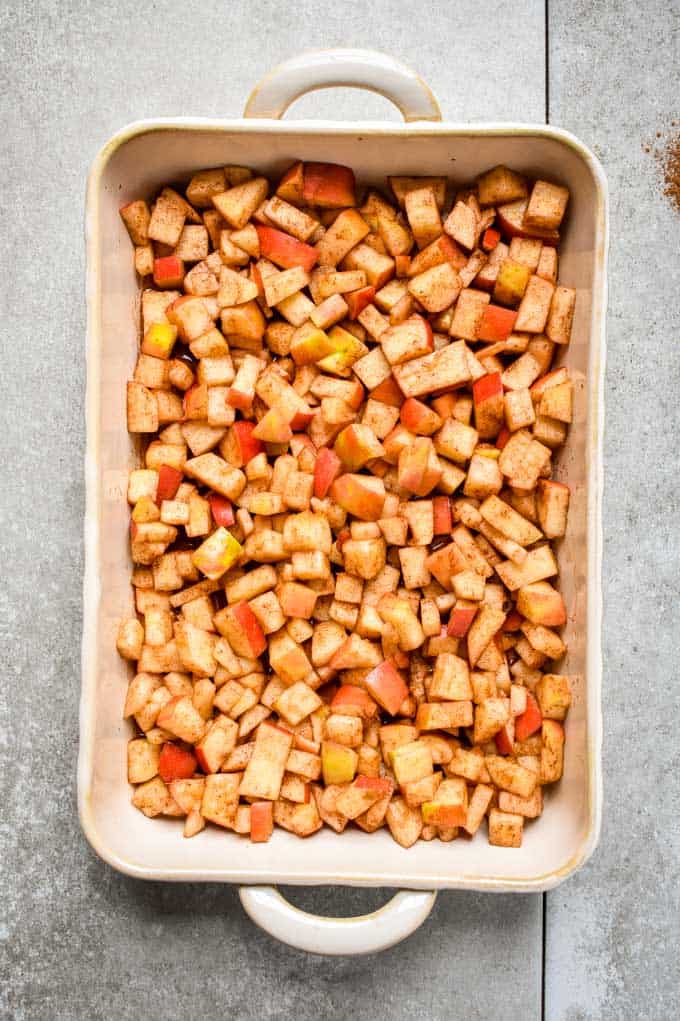 Cinnamon apple oatmeal crumble mixture in baking pan.