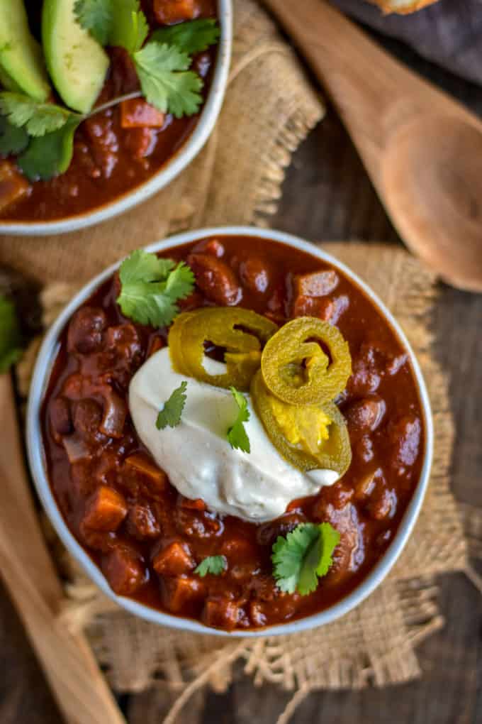 Sweet potato black bean chili with sour cream and jalapenos.