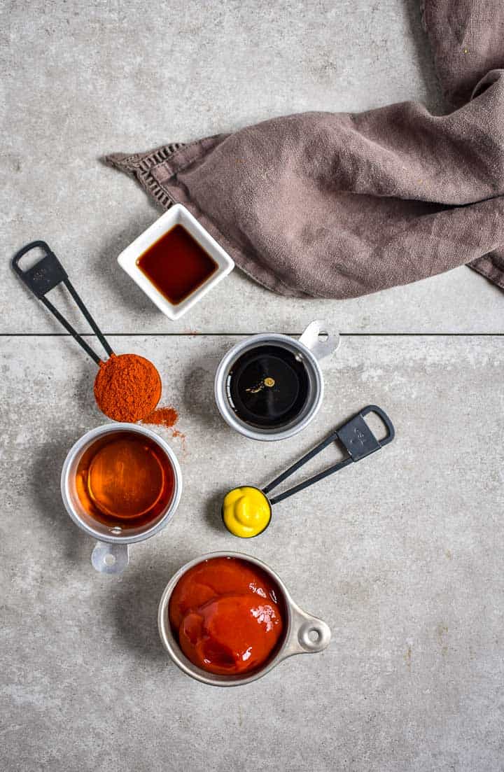 bbq sauce ingredients on counter top with gray dish towel.