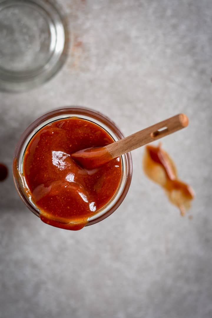 Top view of easy homemade bbq sauce in jar with spoon.