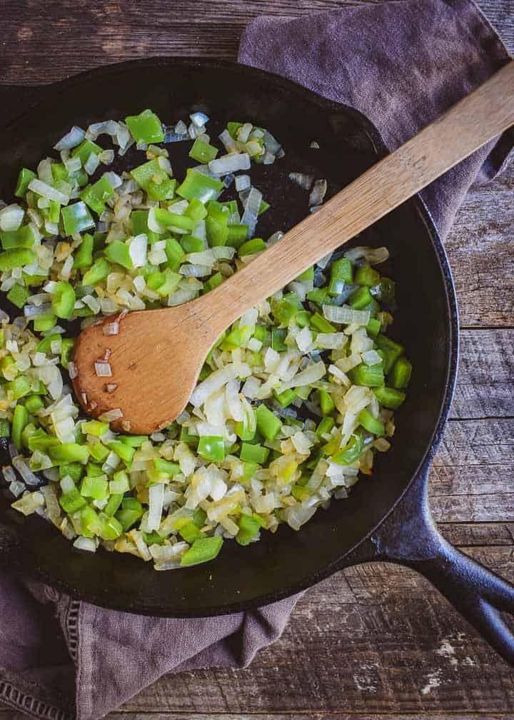 Green peppers and onions in cast iron skillet.