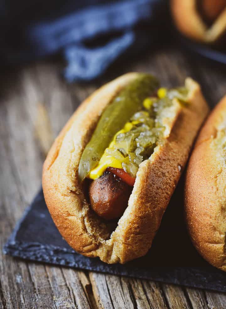 Carrot dog with relish, ketchup, mustard, and pickle.