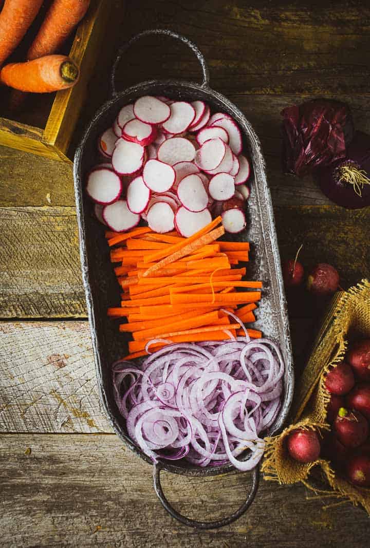 Onion, radishes, and carrots in platter.