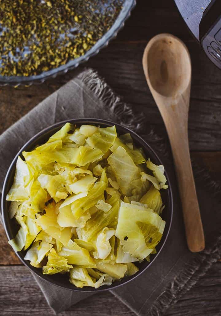 easy instant pot cabbage on napkin with wooden spoon.