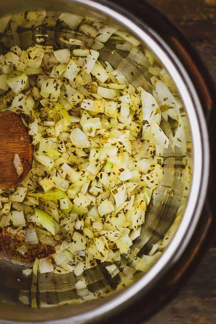 Onions and spices cooking in Instant Pot.