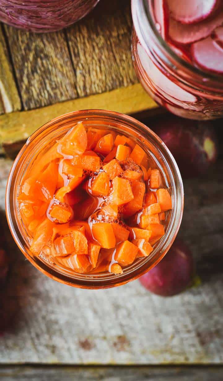 Pickled carrots in jar without lid.