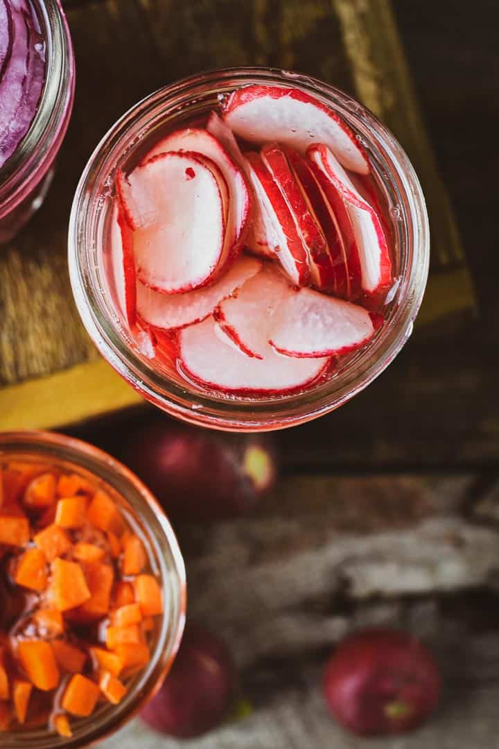 Pickled radishes in jar with no lid.