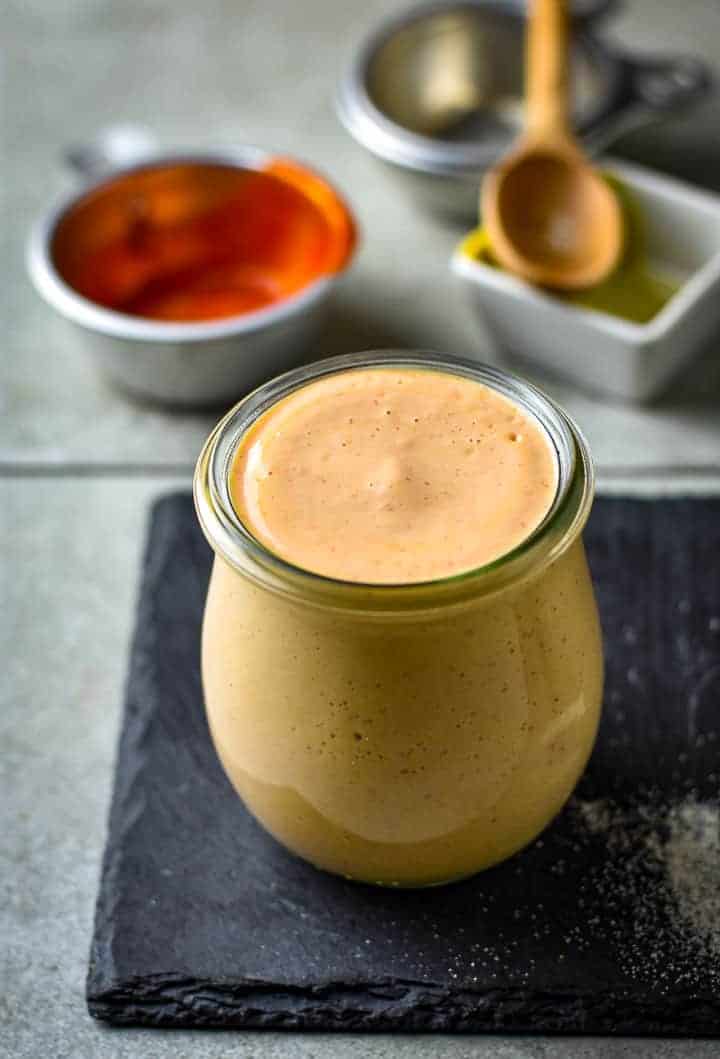 Vegan sriracha mayo in jar without top.