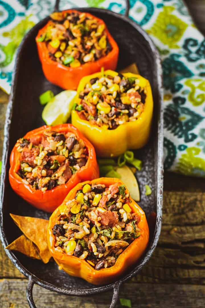 Vegan stuffed bell peppers in tray with chips.