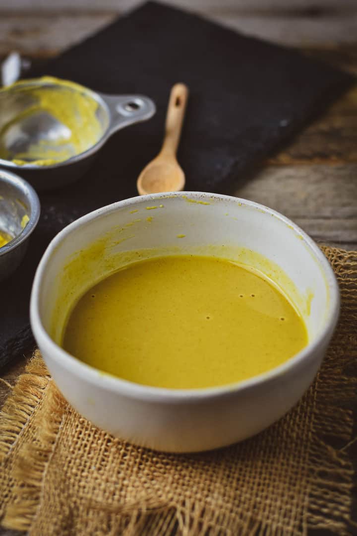 Vegan honey mustard dressing in white bowl.
