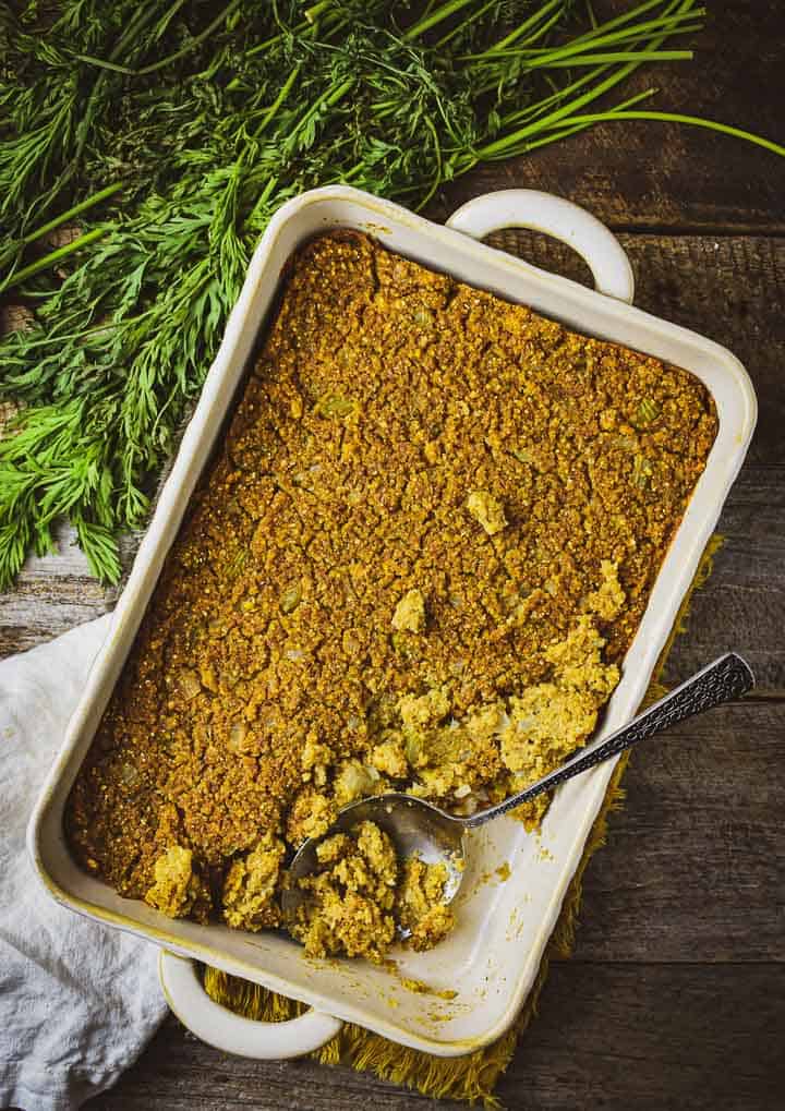 Easy cornbread dressing in baking pan with spoon.