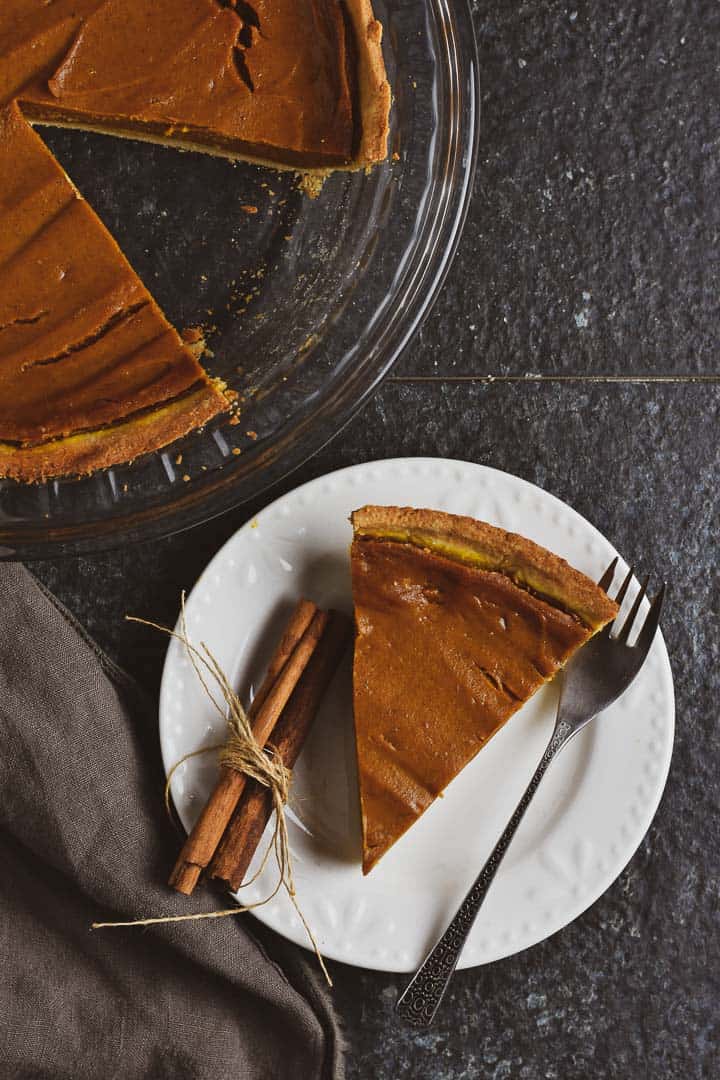 Vegan pumpkin pie on plate with fork.