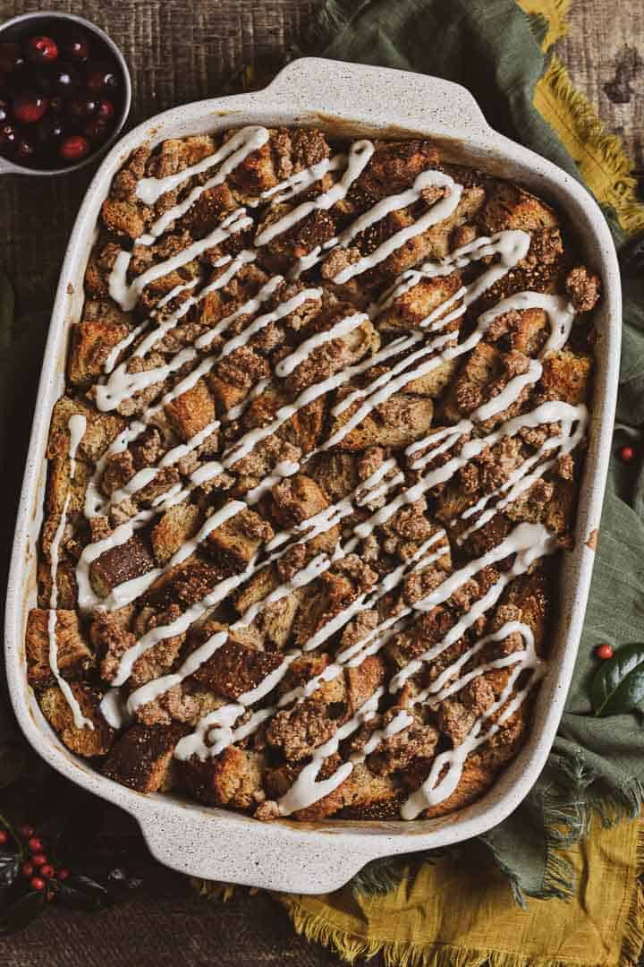 vegan french toast casserole with glaze in dish.