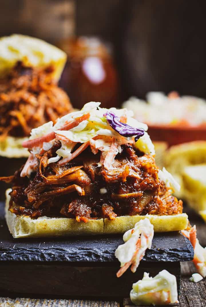 Vegan pulled pork on bread with slaw on top.