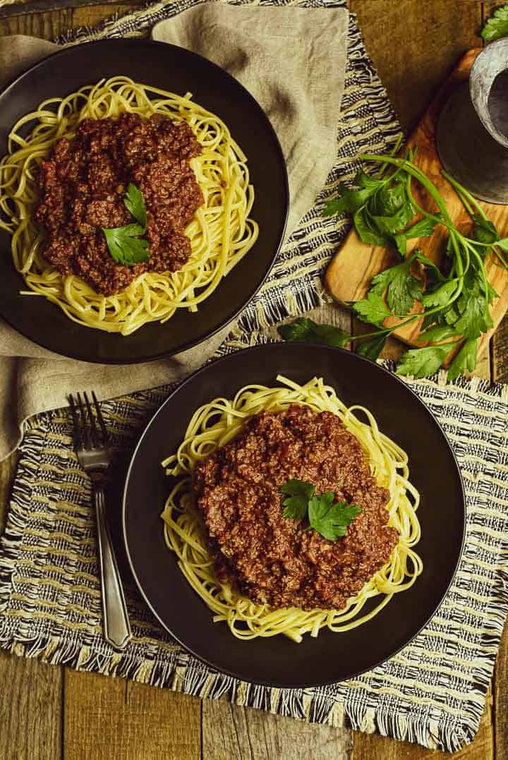 vegan bolognese sauce and pasta on two plates