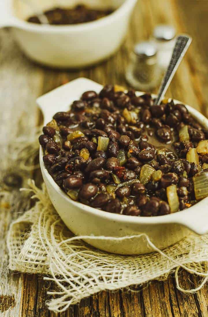 Black beans in bowl with spoon.