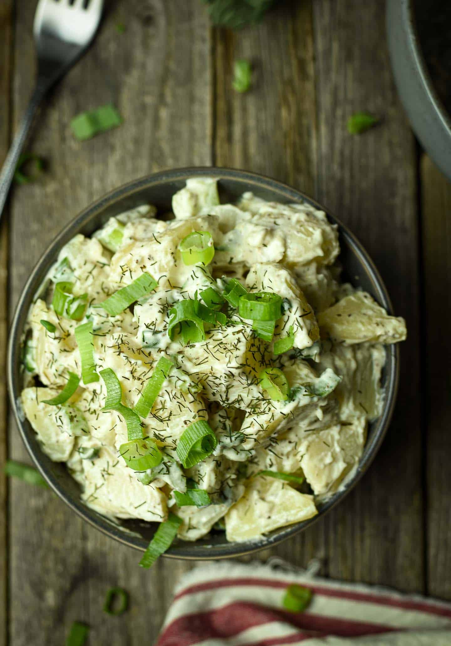 Potato salad with dill and chopped green onions.