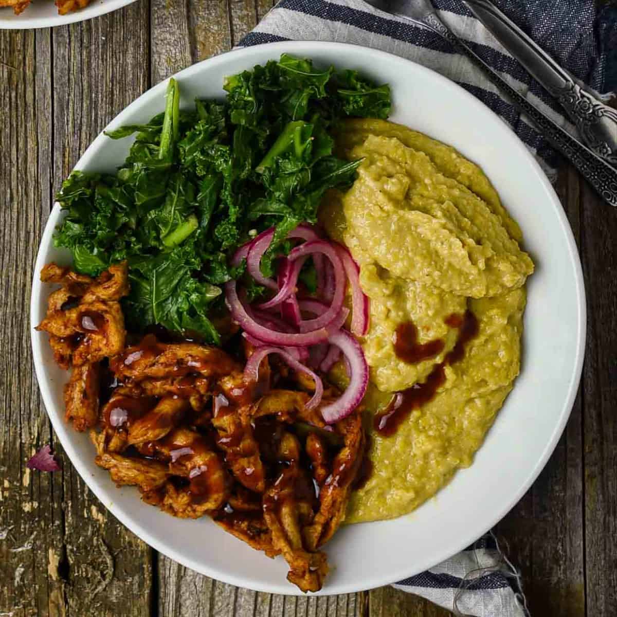 cheesy vegan grits bowl with bbq soy curls and steamed kale