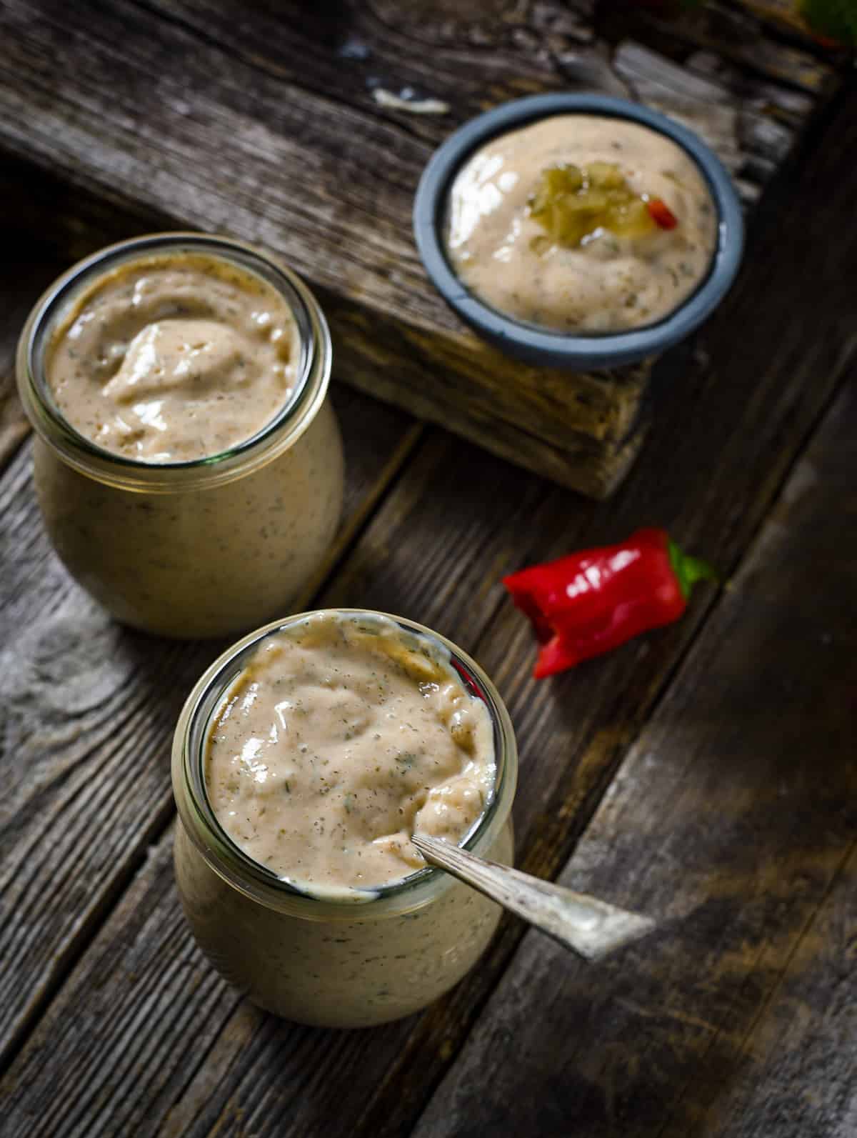 Thousand Island dressing in jar with spoon.