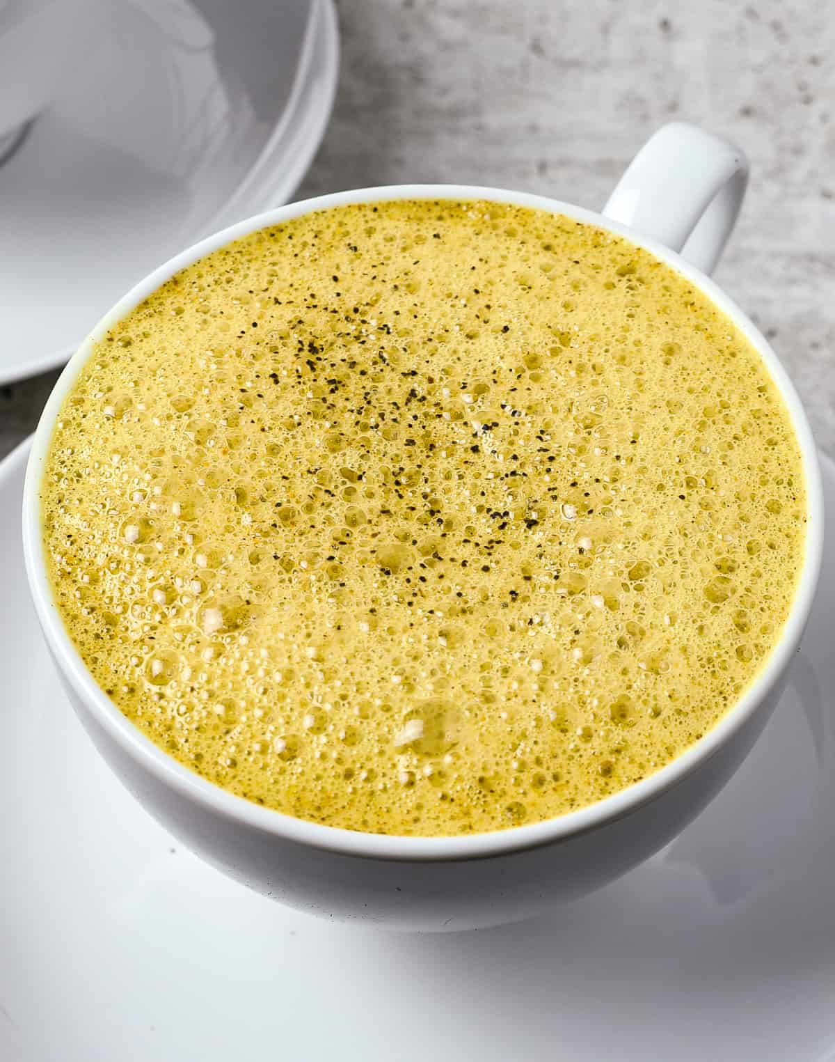 Turmeric latte in white cup.