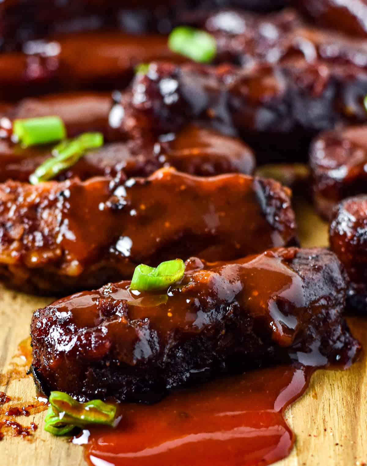 bbq tempeh ribs with green onion on top.