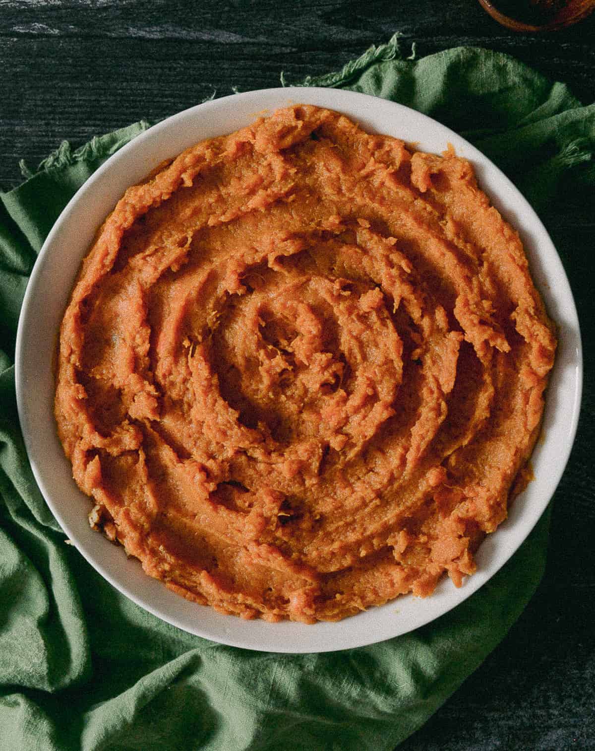 Mashed sweet potatoes in bowl.