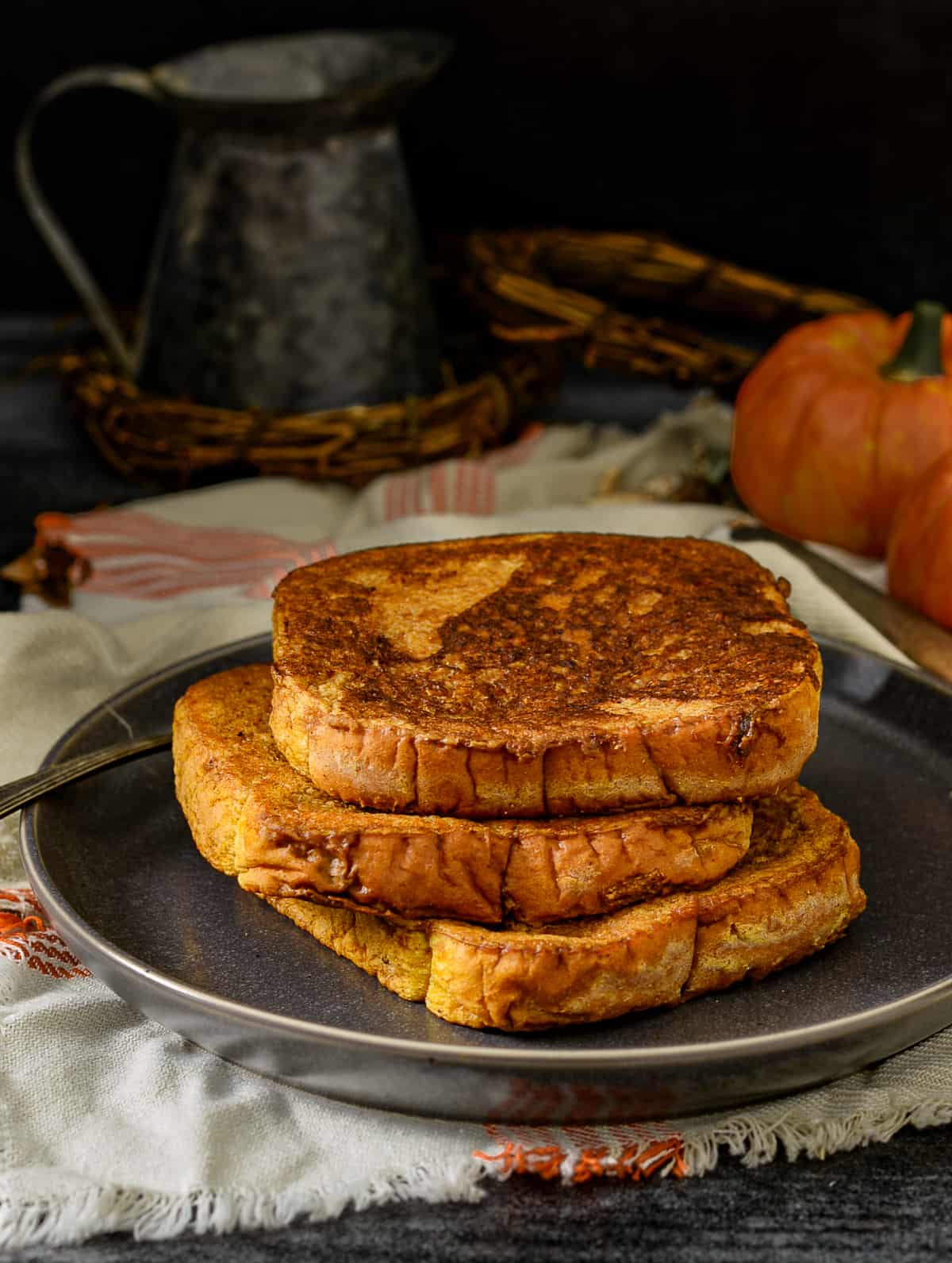 Vegan pumpkin french toast stacked on plate.