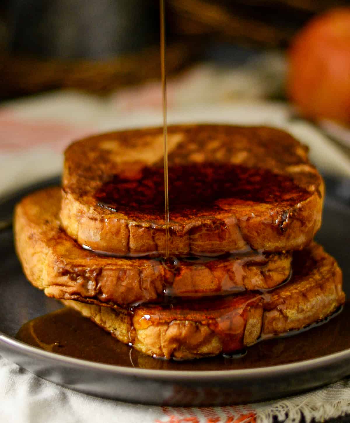 Syrup being poured on top of pumpkin french toast.