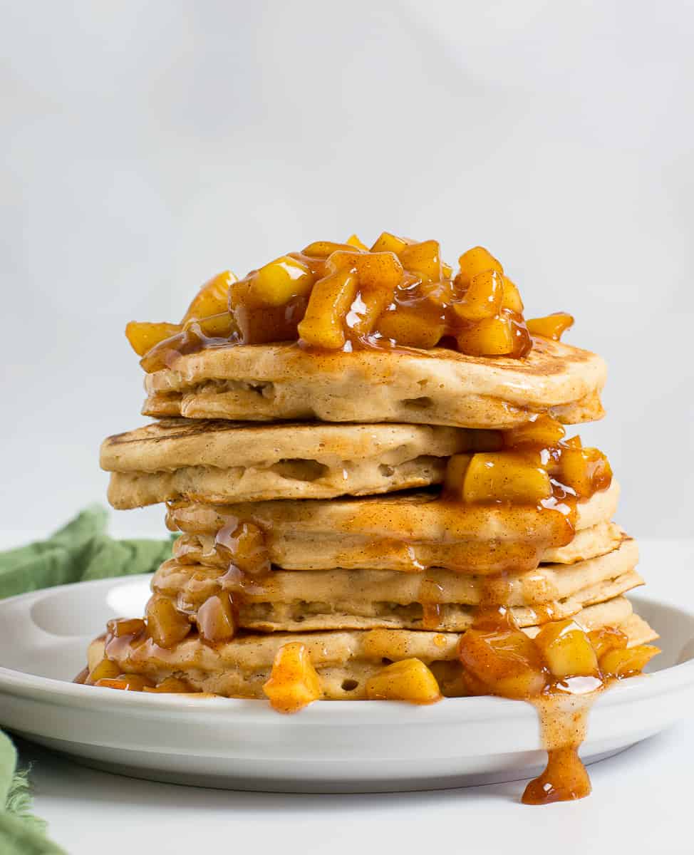 Vegan apple cinnamon pancakes stacked on plate.