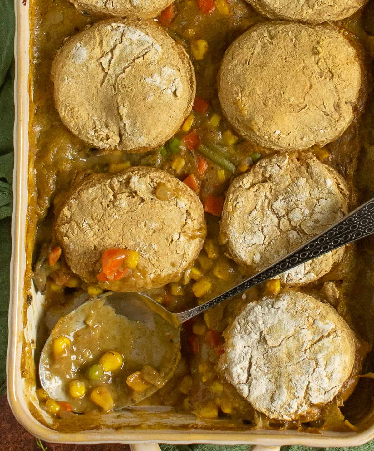 Spoon in baking dish with pot pie.