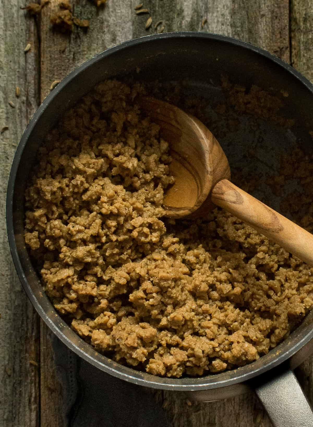 vegan crumbles in pot with spoon