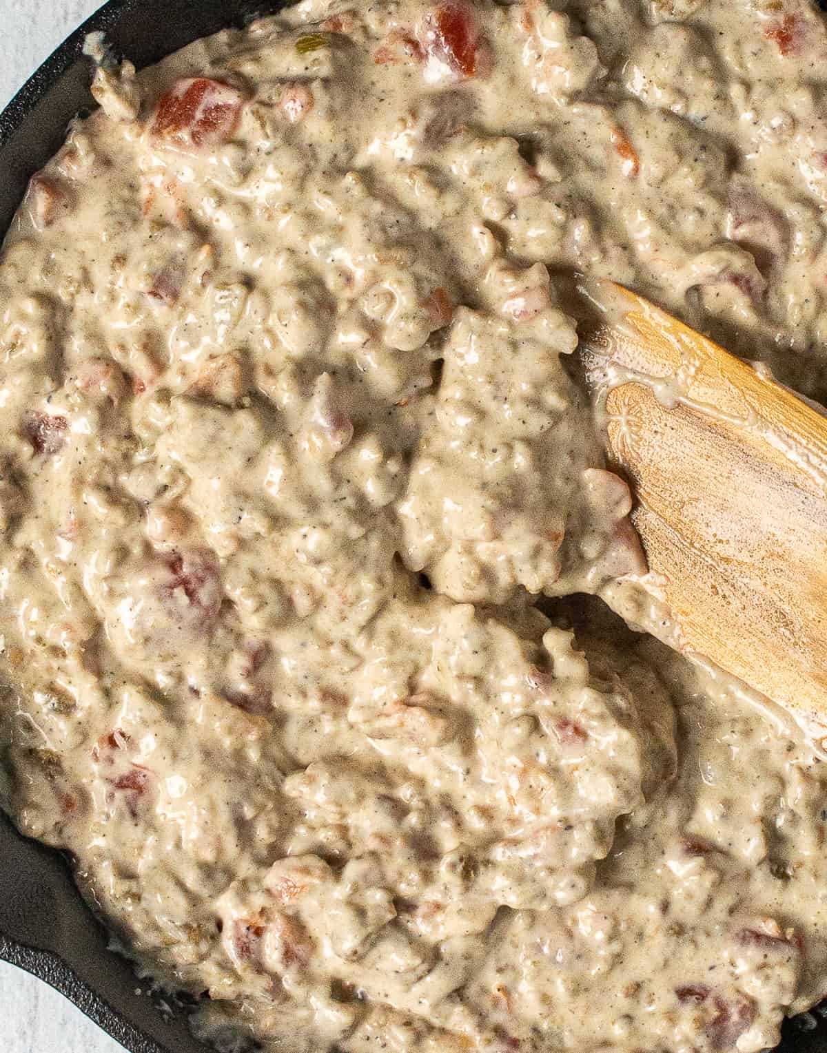 cream cheese sausage dip and wooden spoon