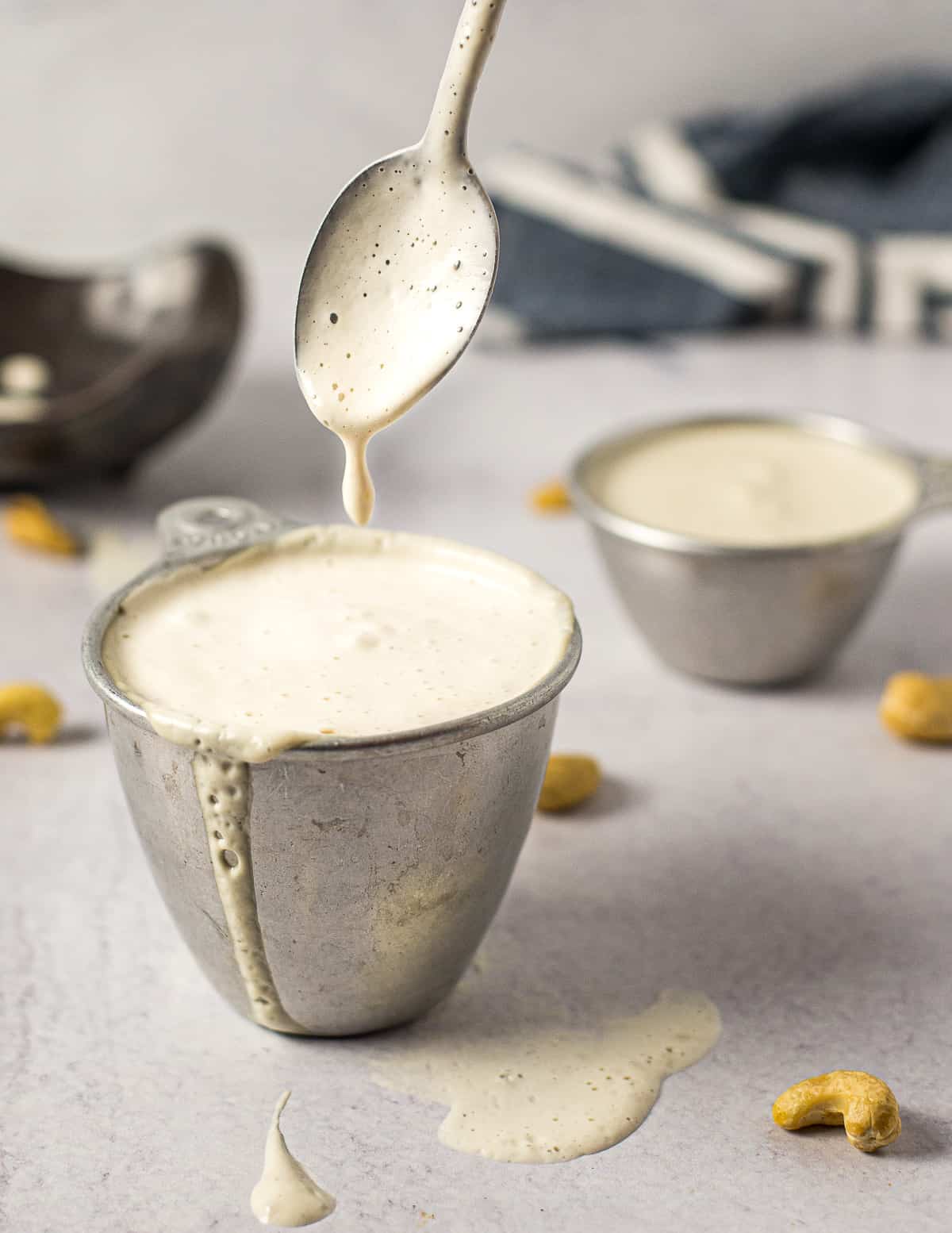 vegan heavy cream dripping from a spoon