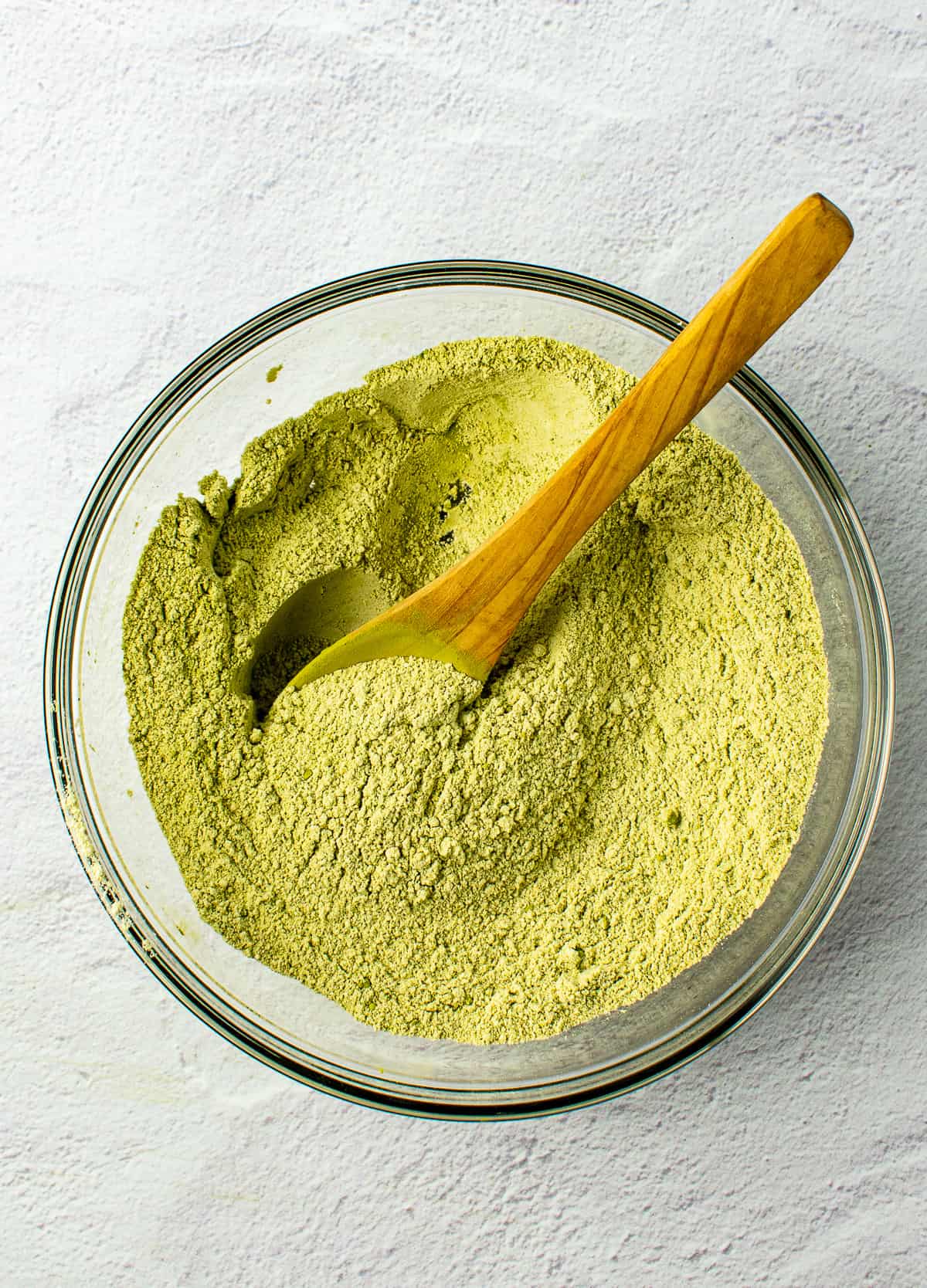flour mixed with matcha and wooden spoon