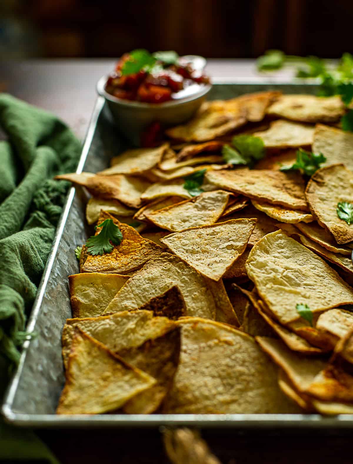 healthy baked tortillas chips on tray with salsa