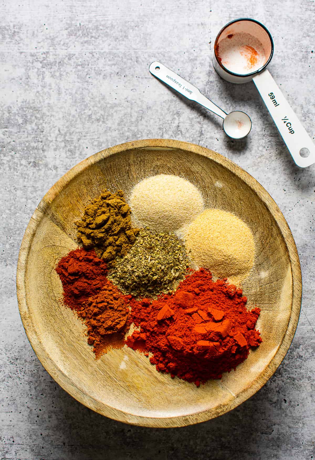 chili powder ingredients on wooden plate