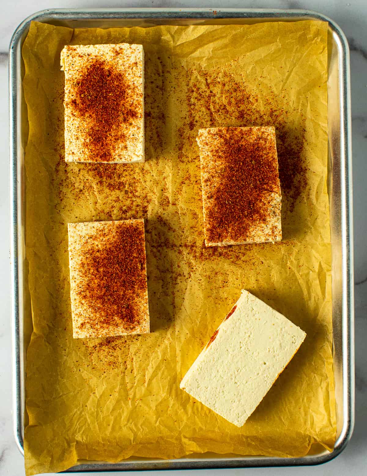 tofu on baking sheet with blackening spice