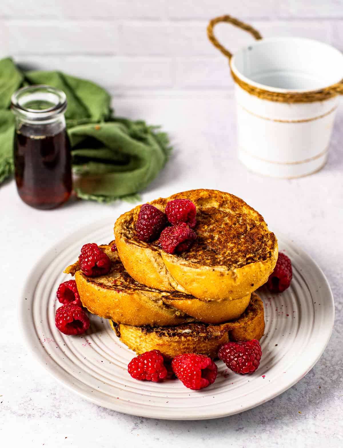 vegan french toast on plate with raspberries