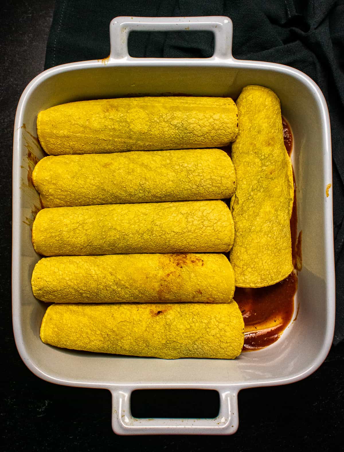 Enchiladas in baking dish.