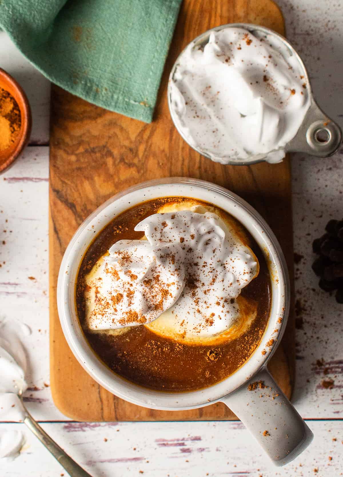 vegan pumpkin spice latte in mug with whipped cream