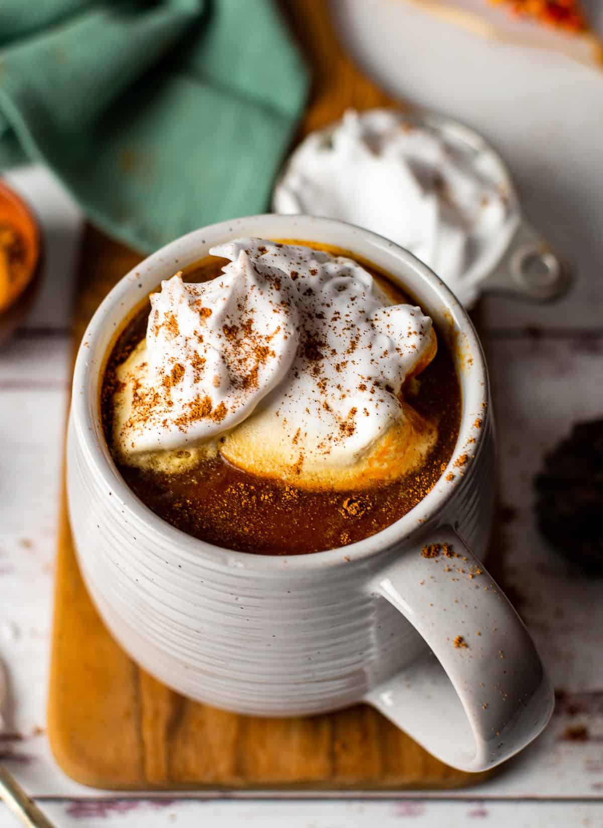vegan pumpkin spice latte in mug with whipped cream