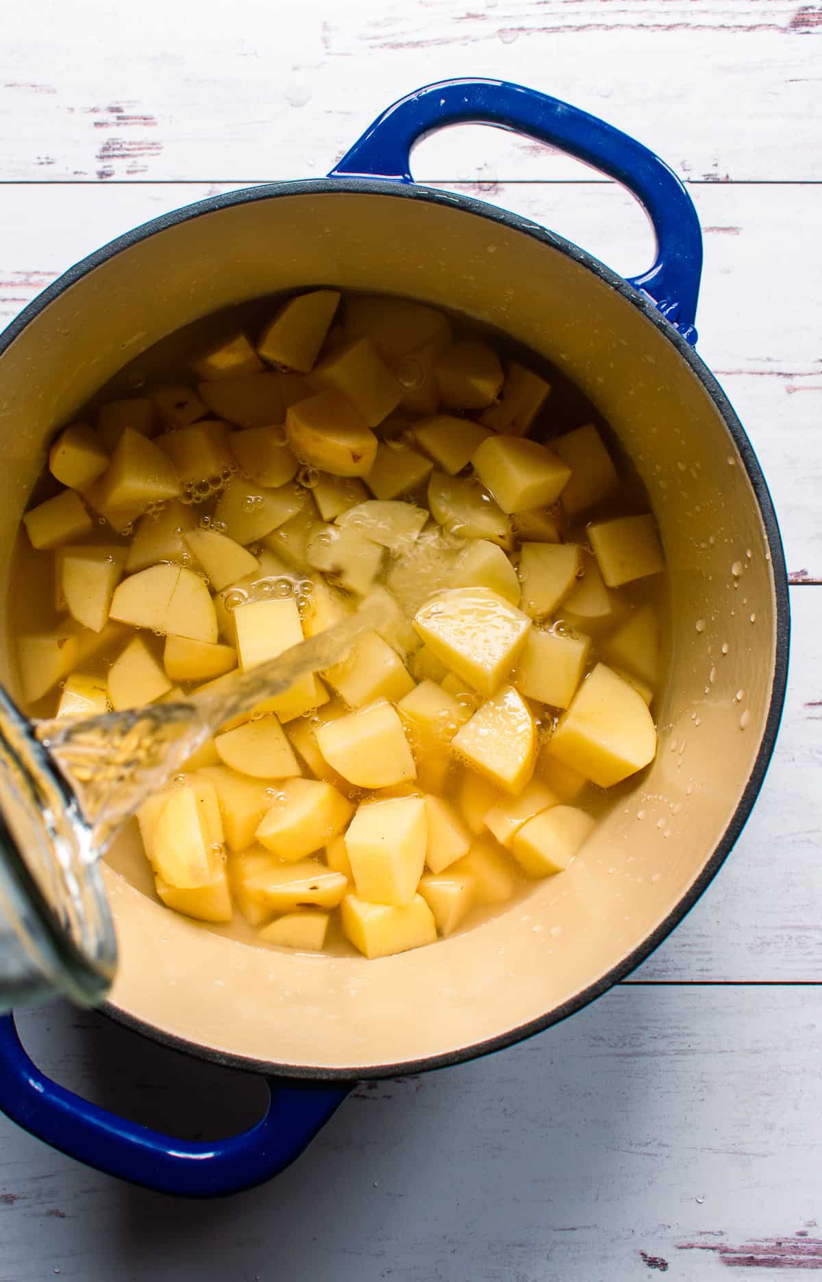 Diced potatoes in pot of water.