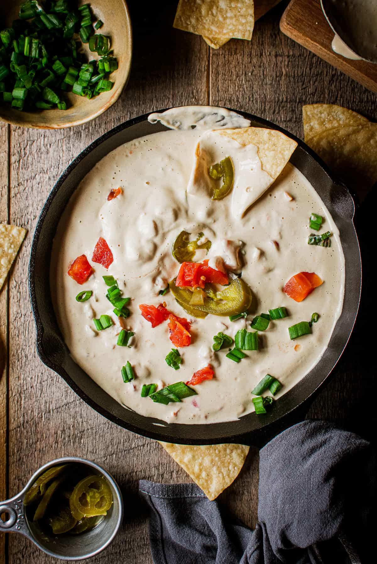 vegan queso in pan with chips